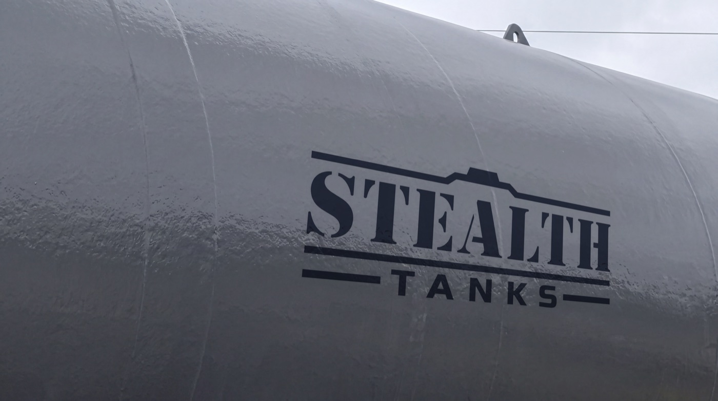 Close view of a double-wall underground storage tank showing the outer jacket